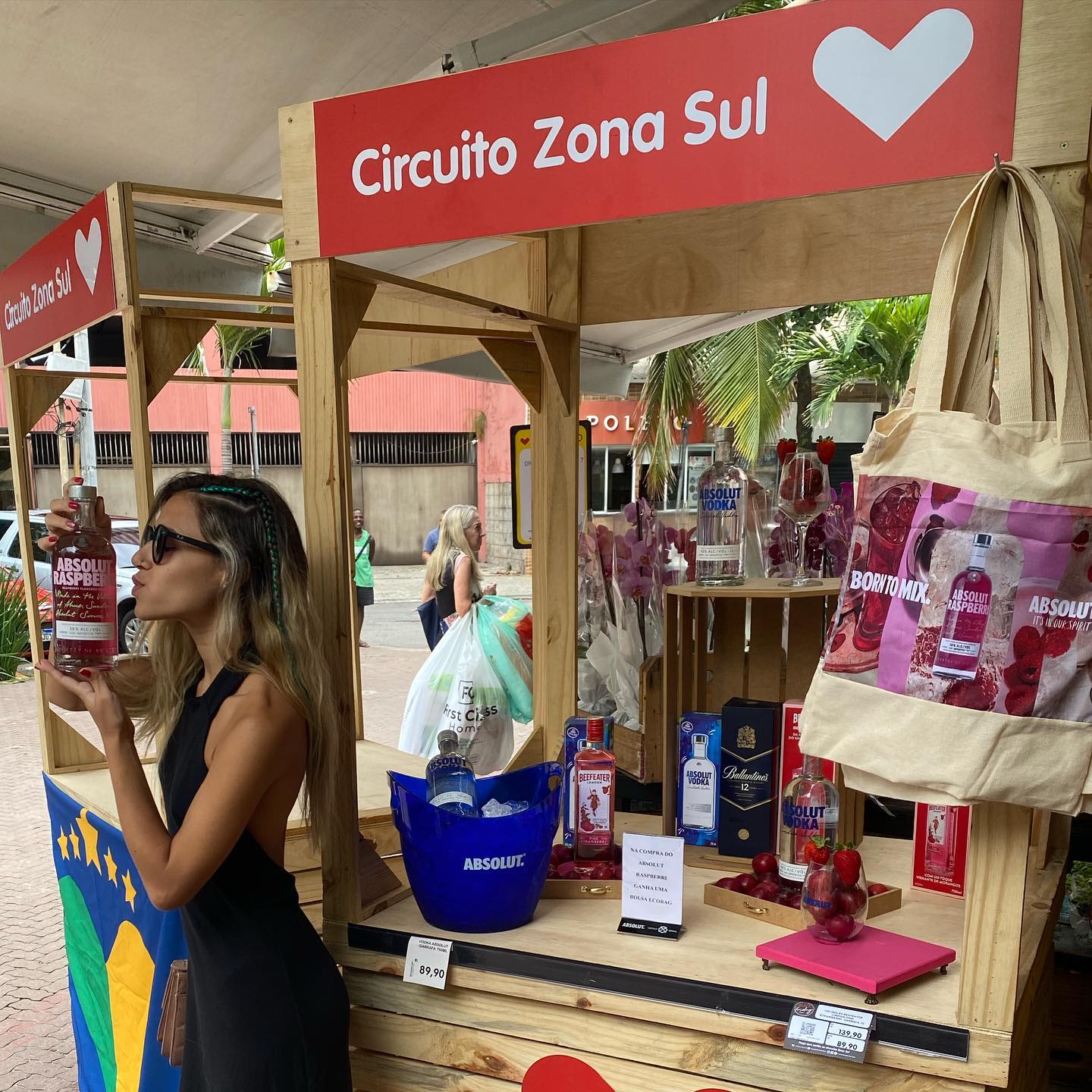 Mulher beijando uma garrafa de vinho em um evento que estava promovendo este produto